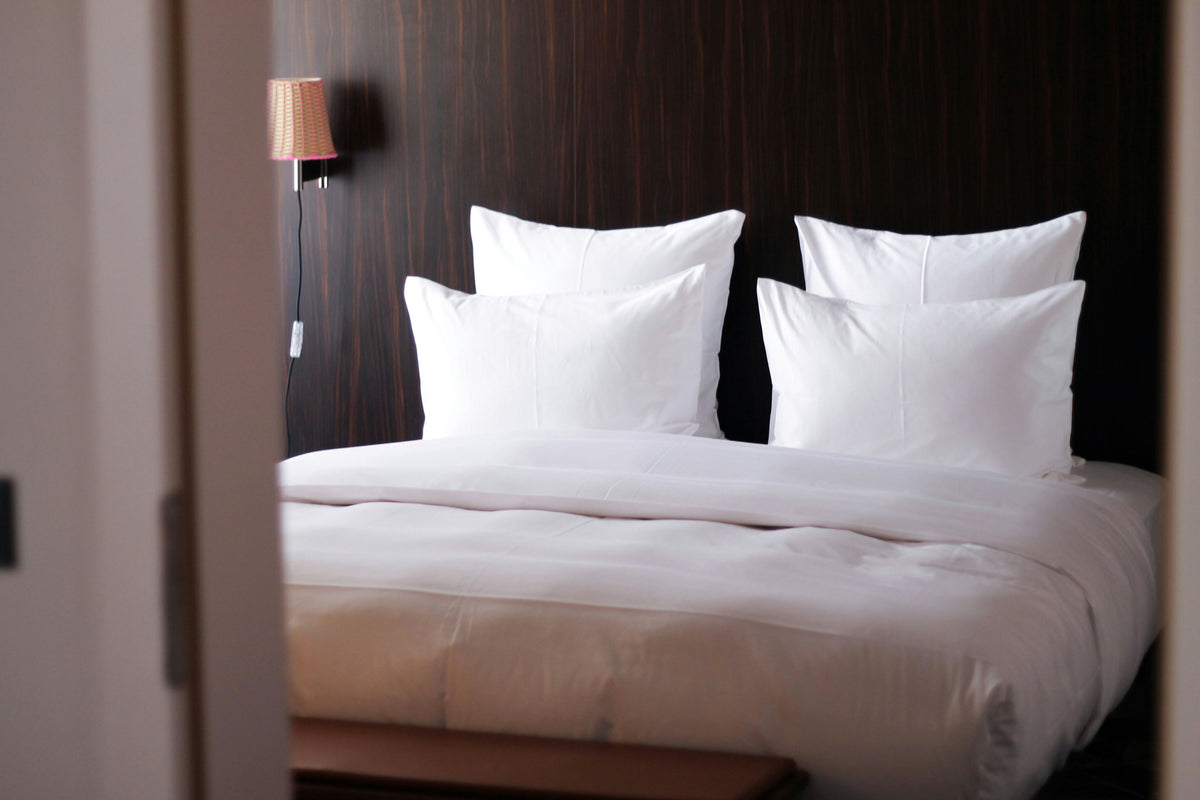 Dark, softly lit hotel suite bed